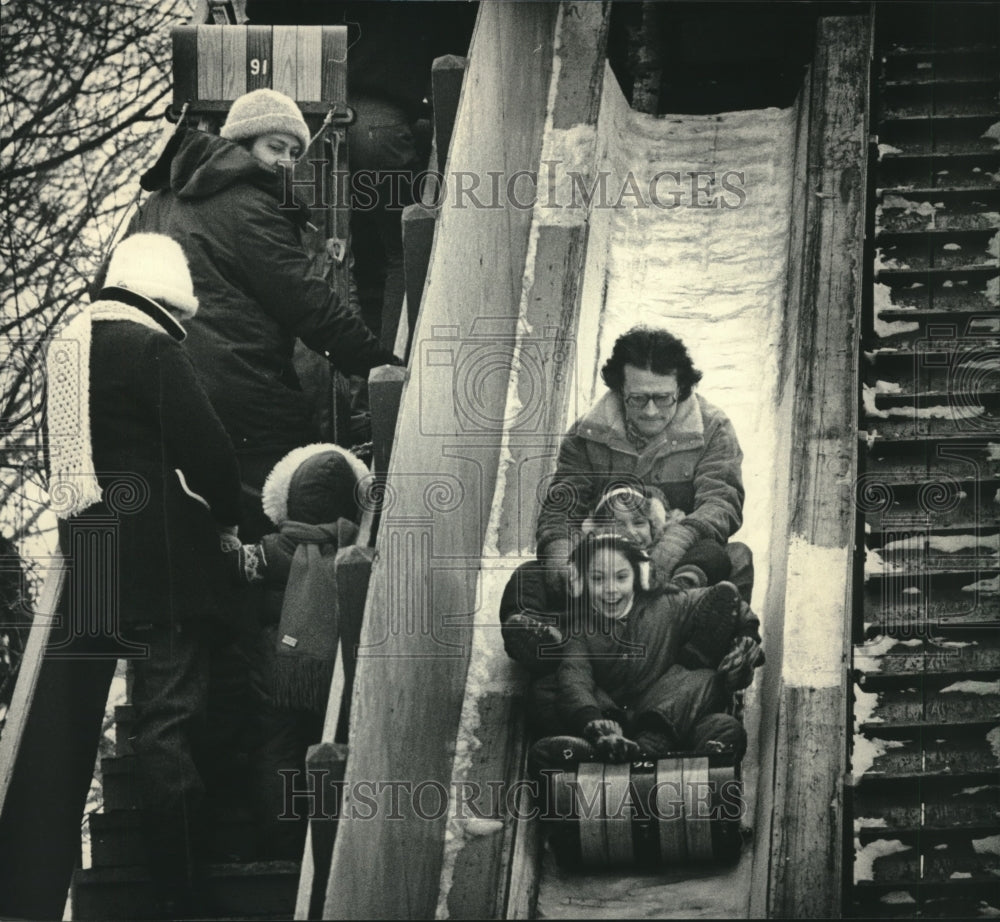 1985, Jack Kastelic with children Kathy and Kim on toboggan hill - Historic Images