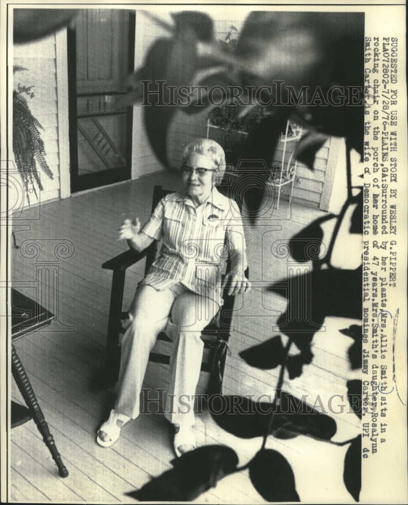 1976 Mrs. Allie Smith surrounded by her plants in a rocking chair - Historic Images