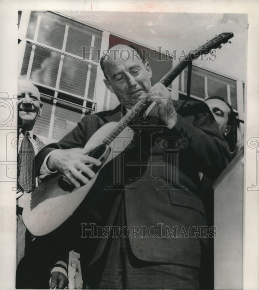 1956, Adlai Stevenson strums guitar at Democratic rally in California - Historic Images