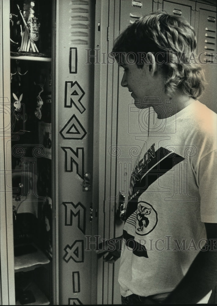 1989, Kevin Hueman shows off decorated locker at school, New Berlin. - Historic Images
