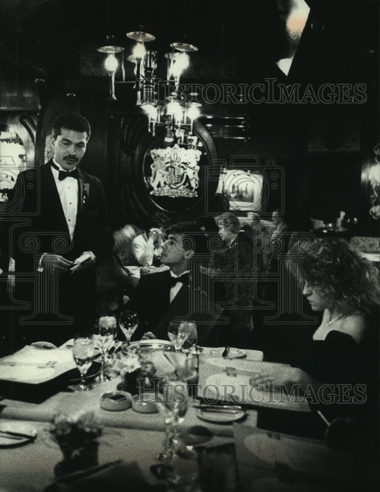 1990 Waiter at English Room explains menu to prom group, Brookfield - Historic Images