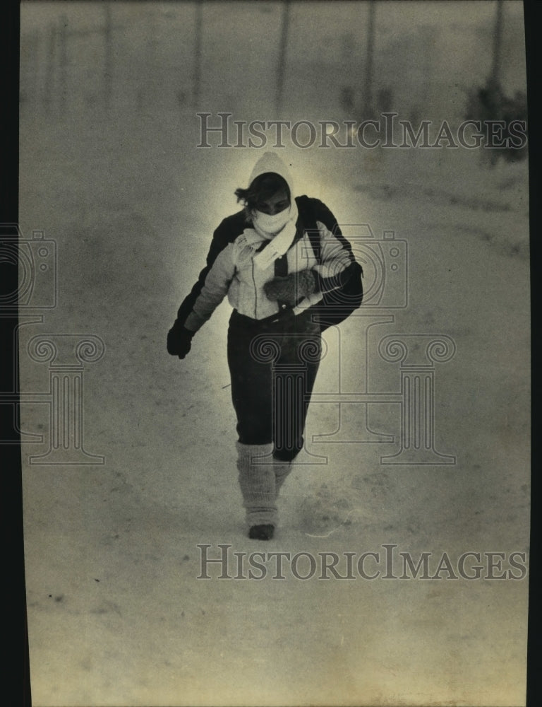 1985 Victoria Zenner walking in Wisconsin Storm - Historic Images