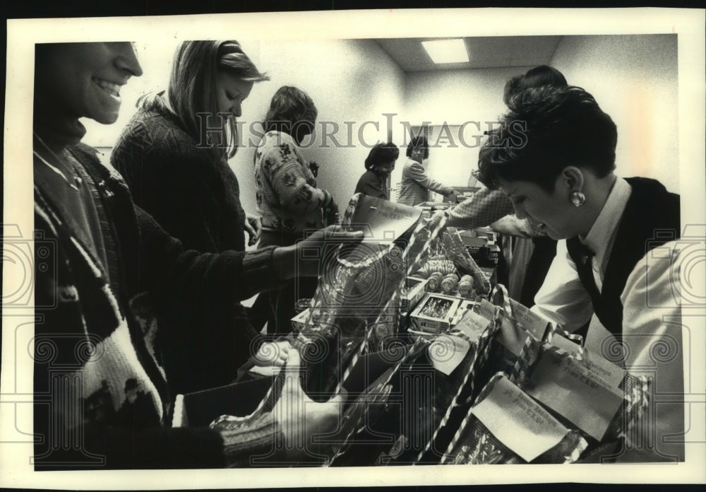 1990, Time Insurance Co. employees fill stockings in Milwaukee - Historic Images