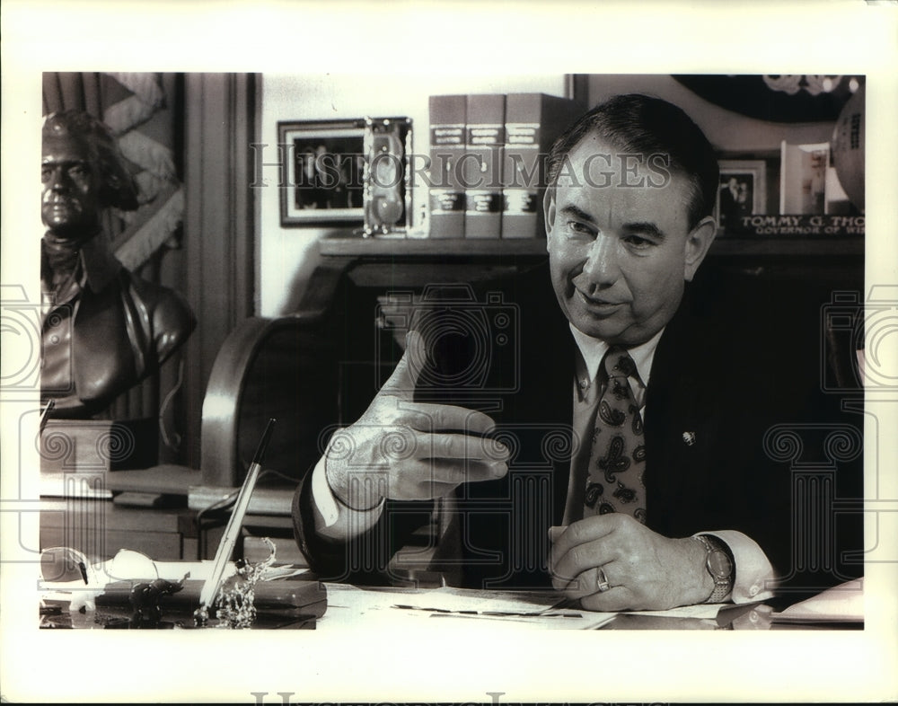 1994 Governor Tommy Thompson Gestures at His Desk - Historic Images