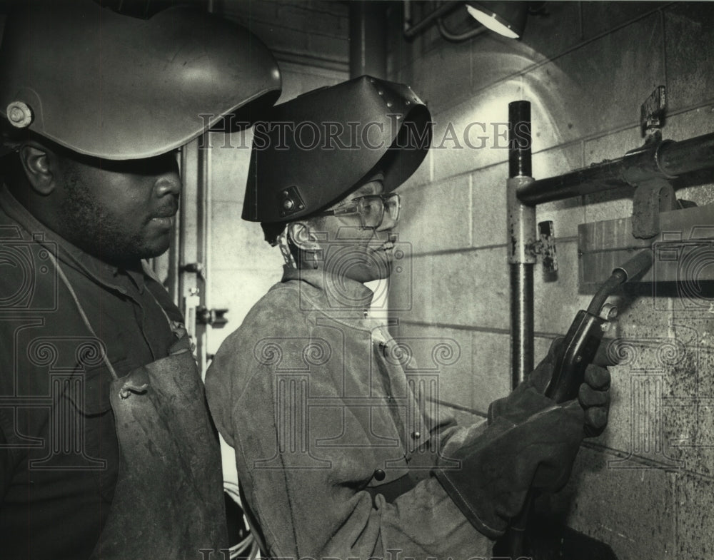 1991, Dorothy Walker teaches Bill Qualls to weld in Milwaukee - Historic Images