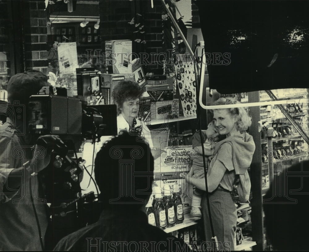 1985, Woman with Baby in Store Filming Television Commercial - Historic Images