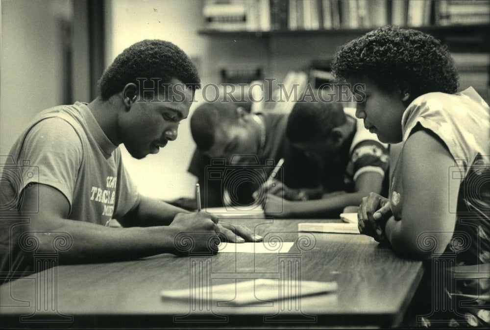 1987 Teen fills out job application at Northcott Neighborhood House - Historic Images