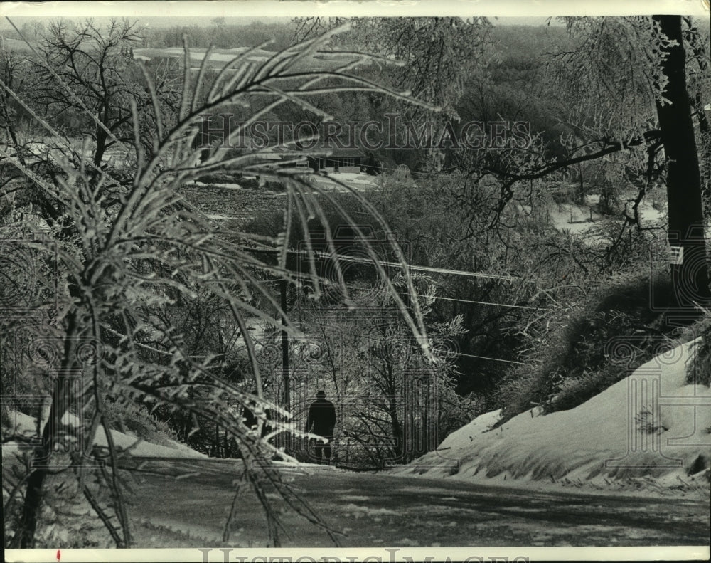 1976, Man walking ice and snow covered landscape Milwaukee, Wisconsin - Historic Images