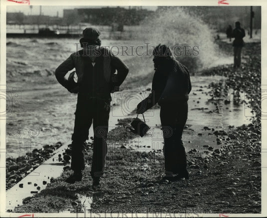 1965, Mr. and Mrs. Krzyzanowski survey storm damage along Milwaukee - Historic Images