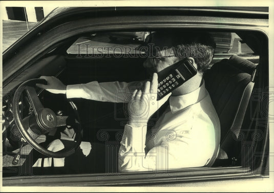 1987, Timothy J. Murphy Uses His Car Phone While Driving in Milwaukee - Historic Images