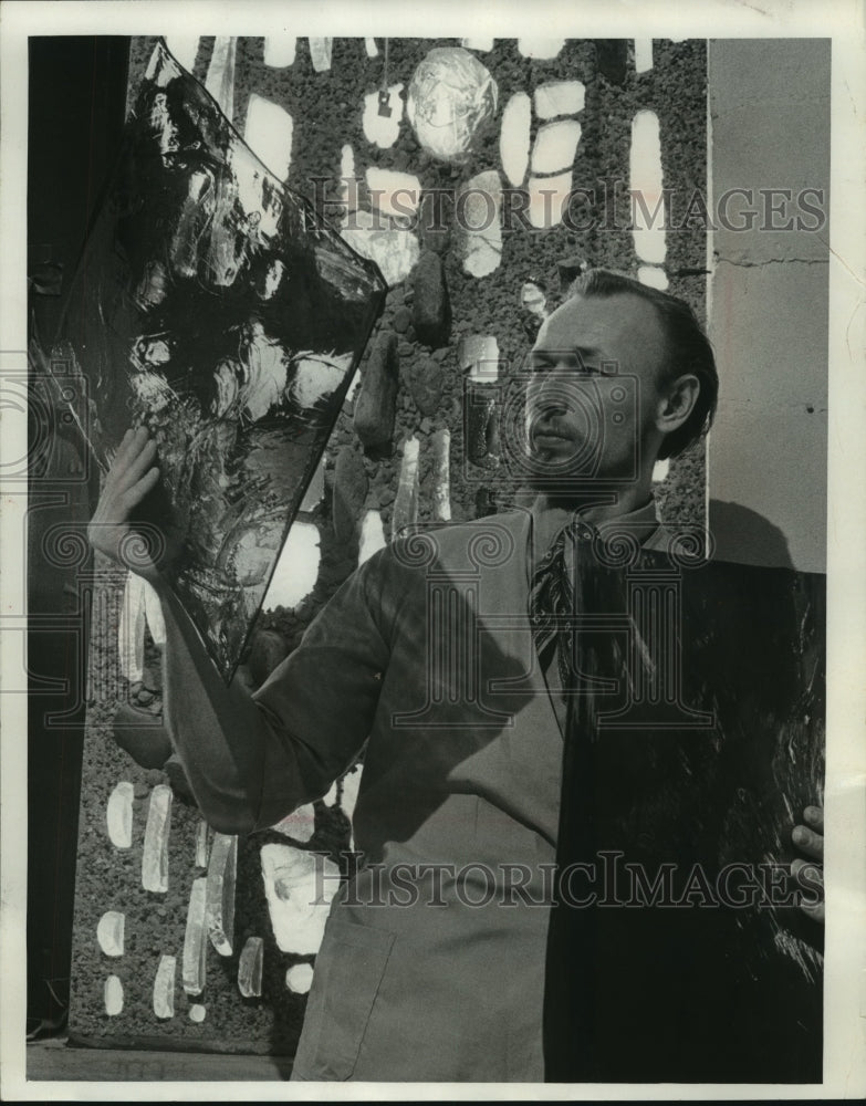 1969, Artist Bernie Gruenke examines sheet stained glass, Wisconsin - Historic Images