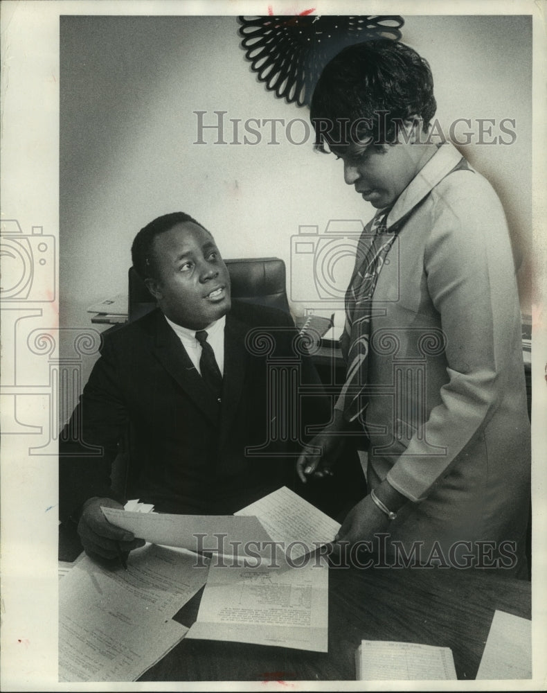 1969, Elijah and Ruth Pitts check a clients application Wisconsin - Historic Images