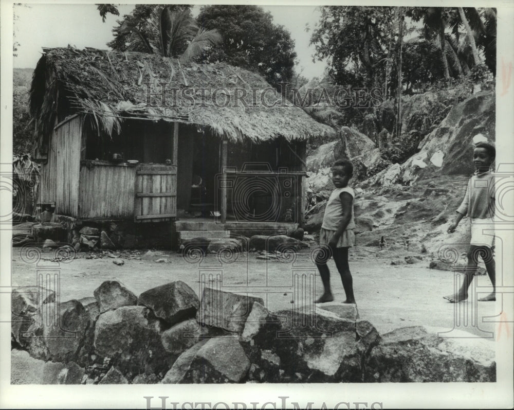 1974 Press Photo Boys Walk in Front of One of the Island Homes in Seychelles-Historic Images