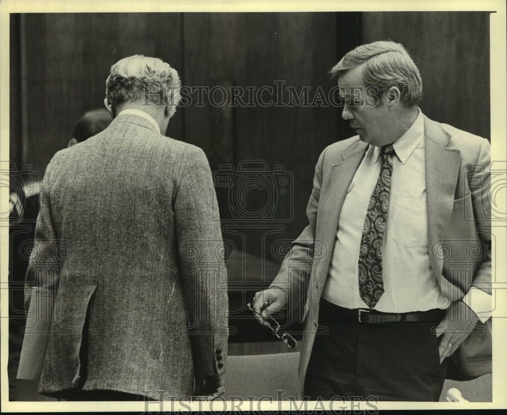 1980, Two men confer at Christ Seraphim Hearing - mjc07770 - Historic Images