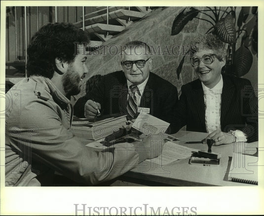 1982, David Pertile, laid-off employee gets $300 from AC Spark Plug - Historic Images