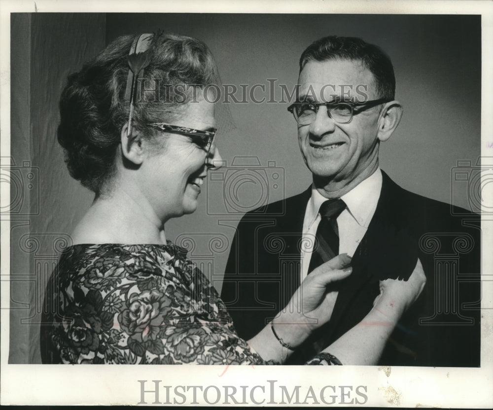 1960, Dr J M Sullivan and wife adjusting his name tag Wisconsin - Historic Images