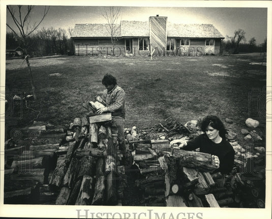 1988 Press Photo The Kuszs Stack Firewood from Trees Downed in Tornado - Historic Images