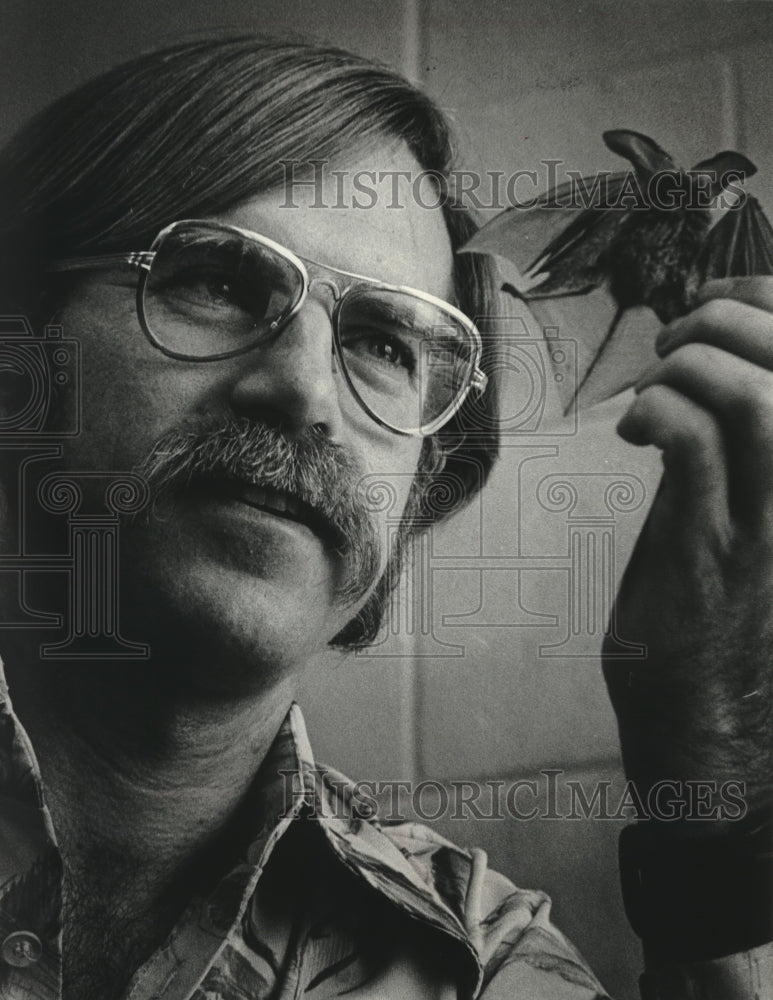 1975 Merlin Tuttle, holding a bat, new curator of mammals at museum. - Historic Images