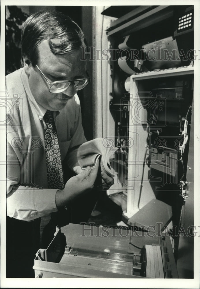 1990, Ron Tatreau, senior processing clerk for Tyme Corporation - Historic Images