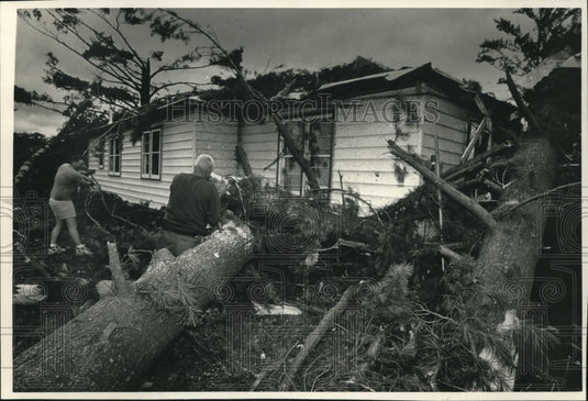 1992 Jim Verstegen and son Mike clear trees after Wisconsin tornado - Historic Images