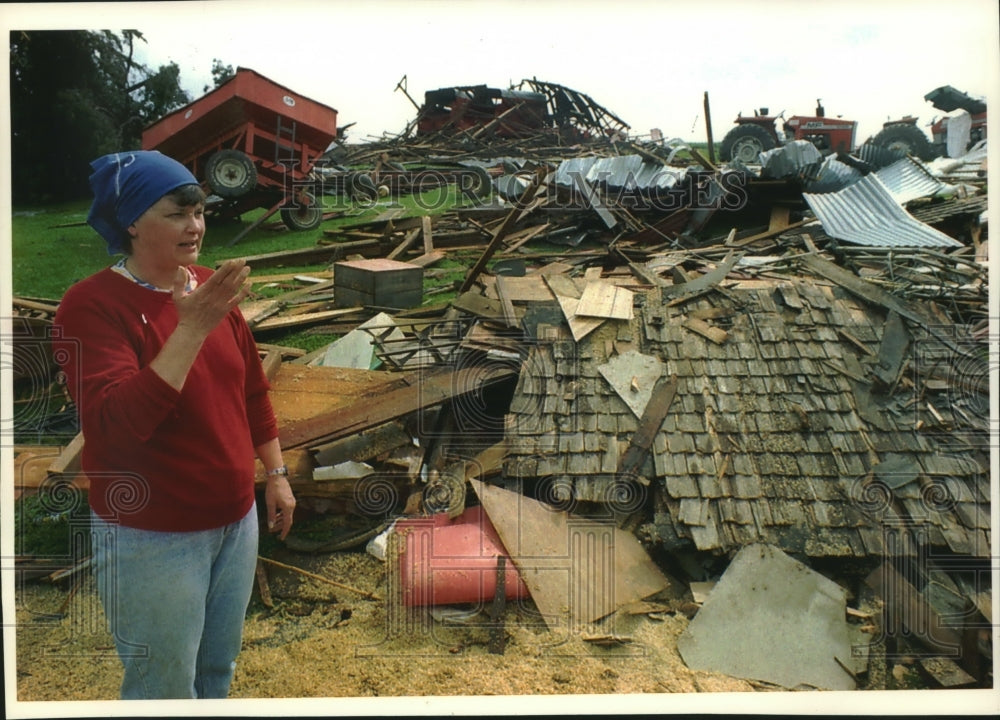 1993, Judy Hofslien stands in farm wreckage after twister - mjc10125 - Historic Images