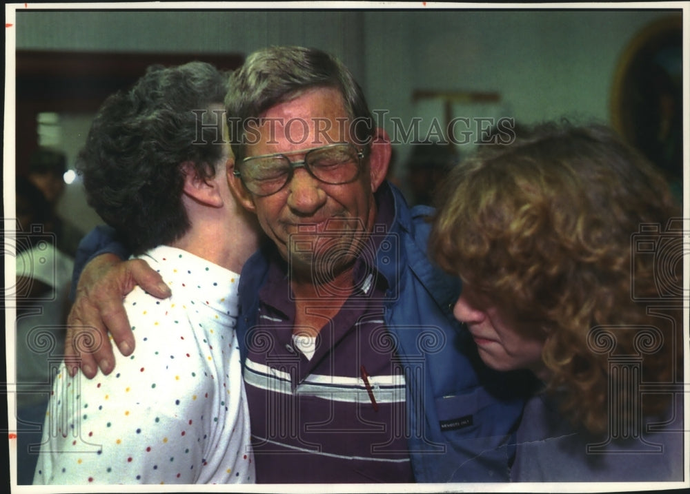 1994, Alabama people hug as tornado death toll climbs to 21 - Historic Images