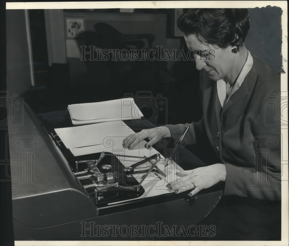 1955, Mrs. G.J. Parri demonstrates automatic signature machine - Historic Images