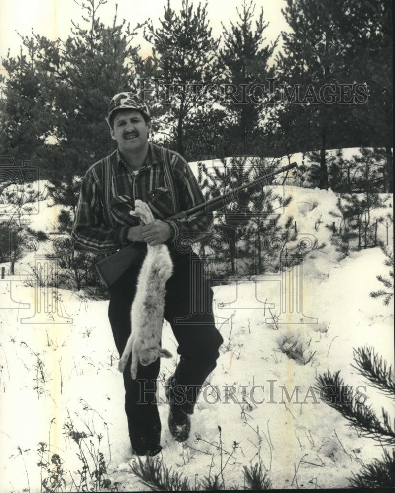 1991, Hunter, Don Taylor show off a snowshoe his dogs helped down - Historic Images