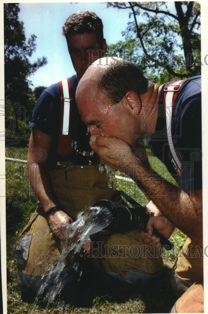 1993, Greenfield firefighters take part in fighting a practice fire - Historic Images