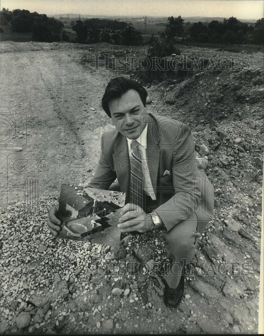 1984 Barry Kiass holds photo of home destroyed by tornado, Wisconsin - Historic Images