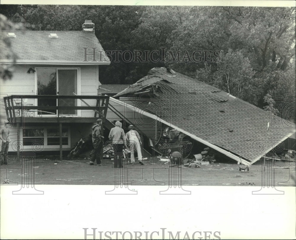 1982, People examine tornado damaged home in Eau Claire, Wisconsin - Historic Images