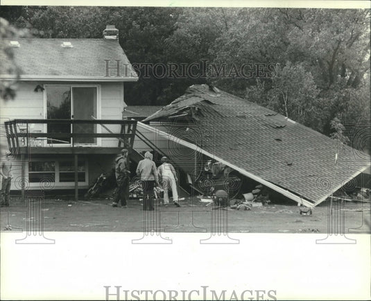 1982, People examine tornado damaged home in Eau Claire, Wisconsin - Historic Images