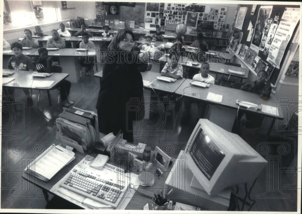 1993 Press Photo 27th Street School teacher Robin Squier adjusts a wall monitor - Historic Images