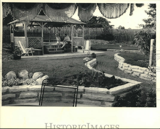 1986, Grace & Oscar Schulman in their backyard hot tub, Wisconsin - Historic Images