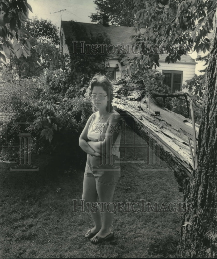 1983 Kathleen Zeman near tree that blew down in her West Allis yard - Historic Images