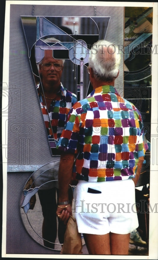 1993 Cardinal Stritch College "Mile of Art" fair-goer checks out art - Historic Images