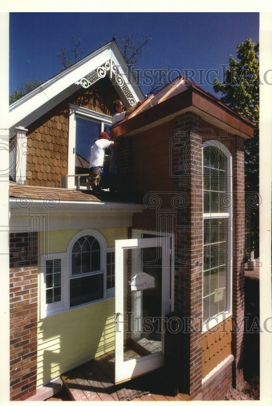 1994, Daryl Moze and Bob Radtke fix gable on B&G's showroom in WI - Historic Images