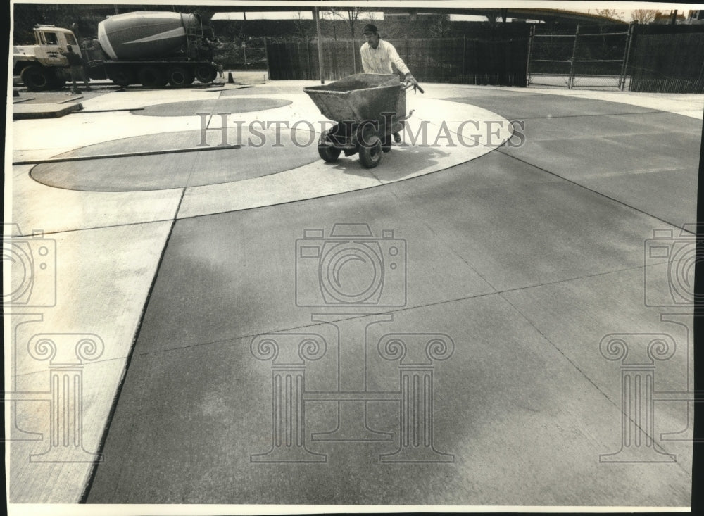 1994, Jeff Krause works on new Summerfest logo set in concrete - Historic Images