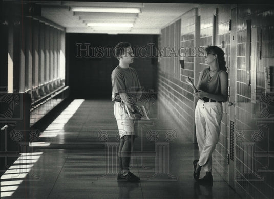 1990, Man and Women talk in hall at Cardinal Stritch College - Historic Images