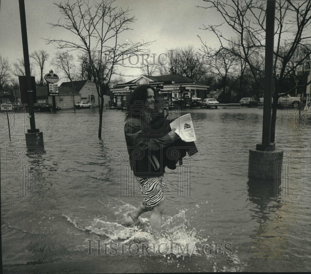 1993, Bill Anderson walks down flooded Main St. Thiensville - Historic Images