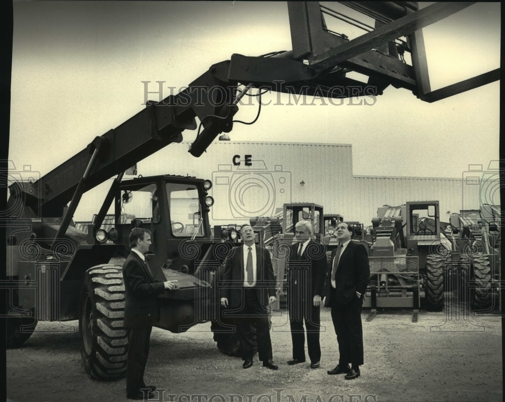 1987, Trak International executives with new Army forklift vehicle - Historic Images