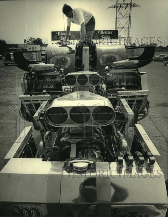 1987, Steve Jasks polished tractor engine at Milwaukee Stadium - Historic Images