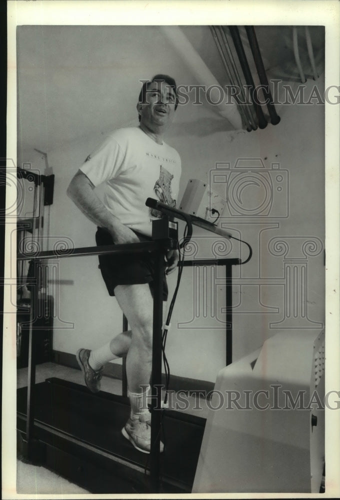 1991 Gov. Tommy G. Thompson works out on his computerized treadmill - Historic Images