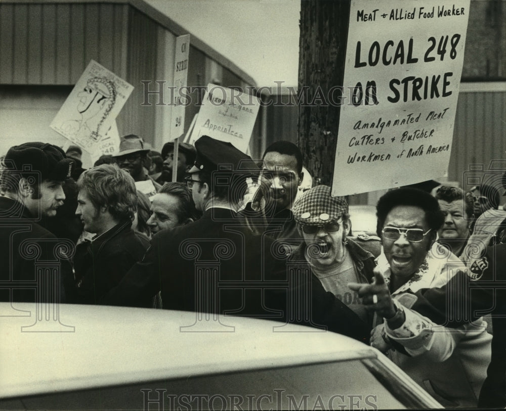 1975, Striking workers picket outside a meat packing company - Historic Images