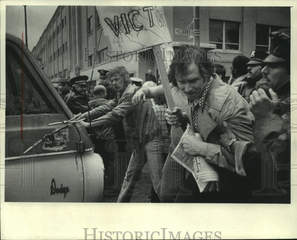 1974, Pickets react to a truck approaching Master Lock Company - Historic Images