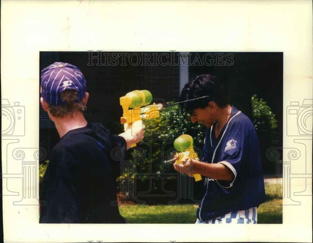 1992 Boys playing with water gun toy - Historic Images