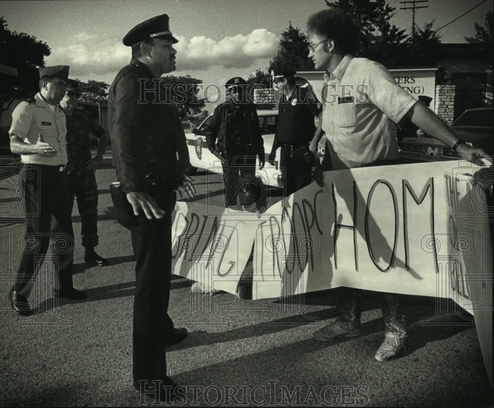 1990 Peace activist Don Timmerman confronts police at protest - Historic Images