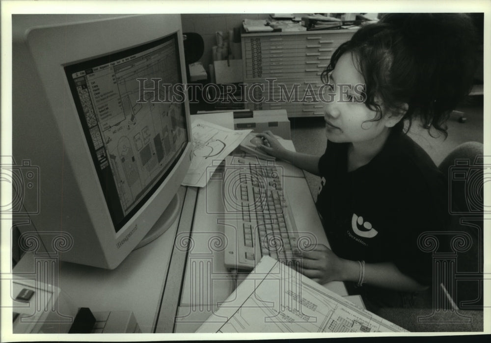 1993, Darouny Kommany works in Summerfest offices with computer - Historic Images