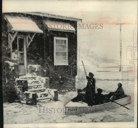 1964, Police rescuing stranded citizens by boat Quincy, Massachusetts - Historic Images