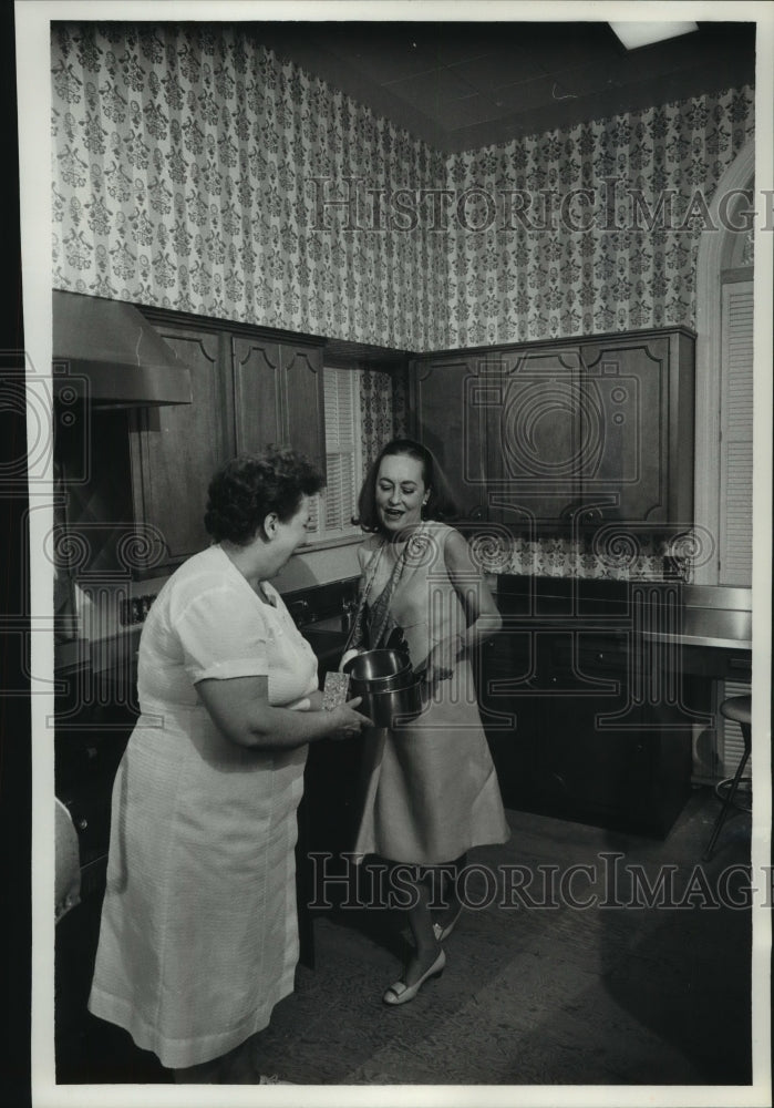 1966, Mrs. Knowles, in kitchen hands cook, Olive Nilson pans - Historic Images